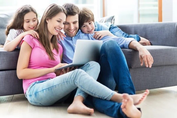  Parents and children looking at a laptop